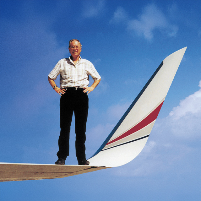 Founder Joe Clarke standing on aircraft wing