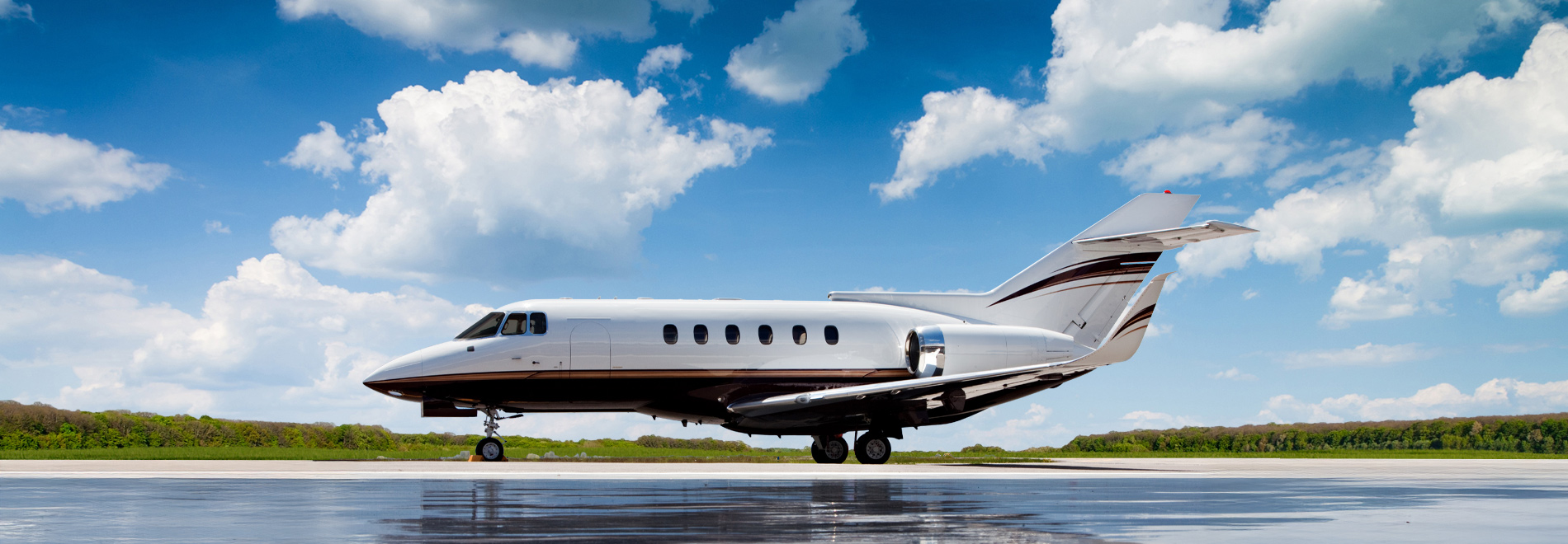 Hawker aircraft on tarmac against a cloudy blue sky