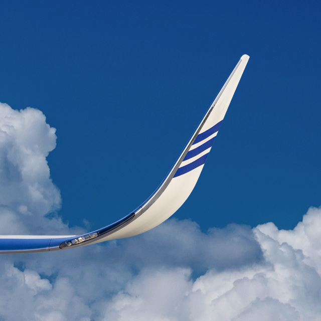aircraft wing against a blue sky
